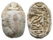 Second Intermediate Period, c. 1650-1550 B.C. Steatite scarab (17x11mm). Base engraved with various signs with the wings of the Horus falcon on the si...