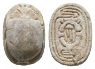 Second Intermediate Period, c. 1650-1550 B.C. Steatite scarab (14x10mm). Base engraved with a scarab within a linear pattern. Intact, once glazed, pie...