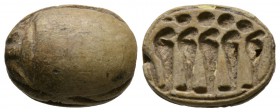 New Kingdom, c. 1550-1075 B.C. Steatite scarab (20x15mm). Base engraved with five cobras surmounted by solar discs. Intact, once glazed, pierced for m...