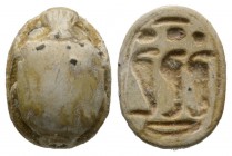 New Kingdom, c. 1550-1075 B.C. Steatite scarab (16x13mm). Base engraved with three cobras surmounted by solar discs. Intact, once glazed, pierced for ...