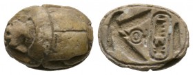 New Kingdom, c. 1504-1075 B.C. Steatite scarab (15x11mm). Base engraved with a falcon with open wings protecting the cartouche of Tuthmosis III. On th...