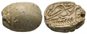 New Kingdom, c. 1386-1075 B.C. Steatite scarab (20x15mm). Base decorated with a Uraeus (Royal cobra), a crocodile and a palm branch. On top, partially...
