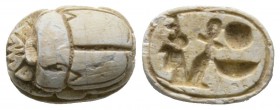 New Kingdom, c. 1386-1075 B.C. Steatite scarab (15x10mm). Base engraved with the name of the Pharaoh Amenhotep III (Amenophis III). Intact, once glaze...