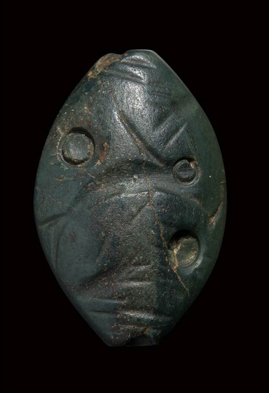 A minoan amygdaloid green jasper engraved seal.Fish with talismanic symbols .
...