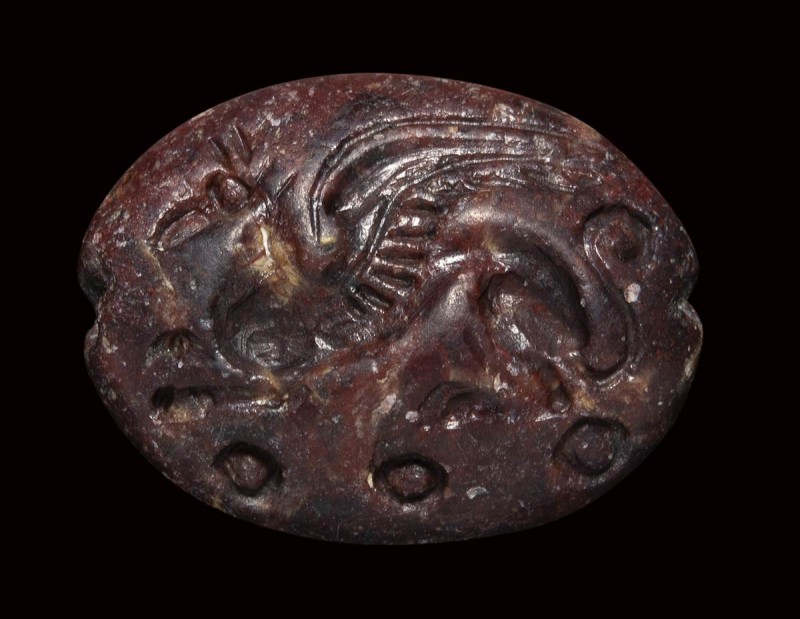 A mycenaean red jasper engraved seal. Griffin. 

2nd millenium B.C.

12 x 16...