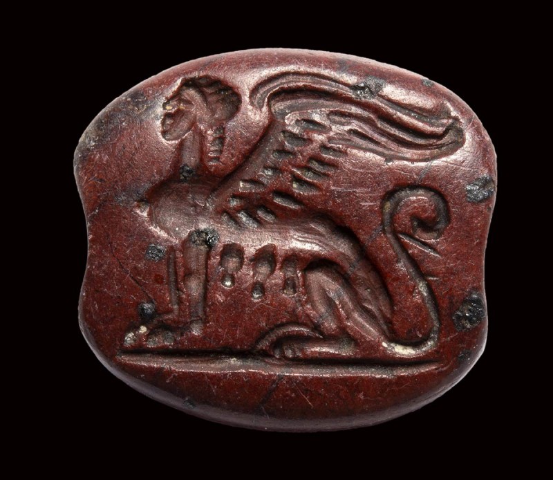 An archaic greek red jasper engraved seal. Seated sphinx. 

Beginning 1st mill...