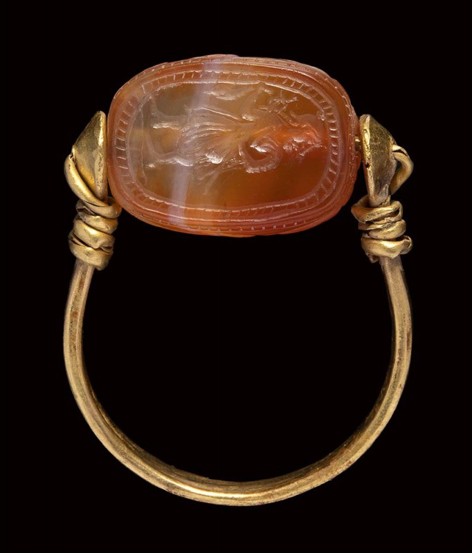 An etruscan agate scarab intaglio, mounted on an ancient gold ring. Hermes.

5...