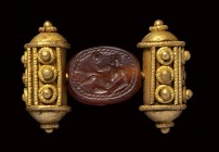 An  etruscan carnelian scarab intaglio, mounted on an ancient gold ring. Athlete.