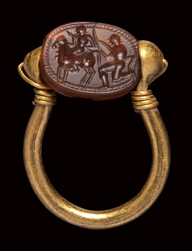 An etruscan carnelian scarab intaglio, mounted on an ancient gold ring. Warrior ...