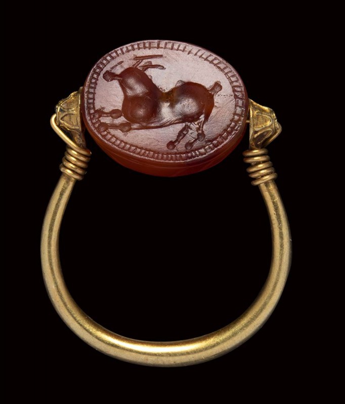 An etruscan carnelian scarab mounted on an ancient gold ring. Antelope. 

4th ...