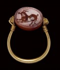 An etruscan carnelian scarab mounted on an ancient gold ring. Antelope.