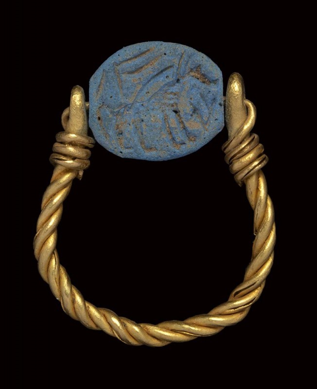 A phoenician blue glass paste scarab intaglio, mounted on an ancient gold ring. ...