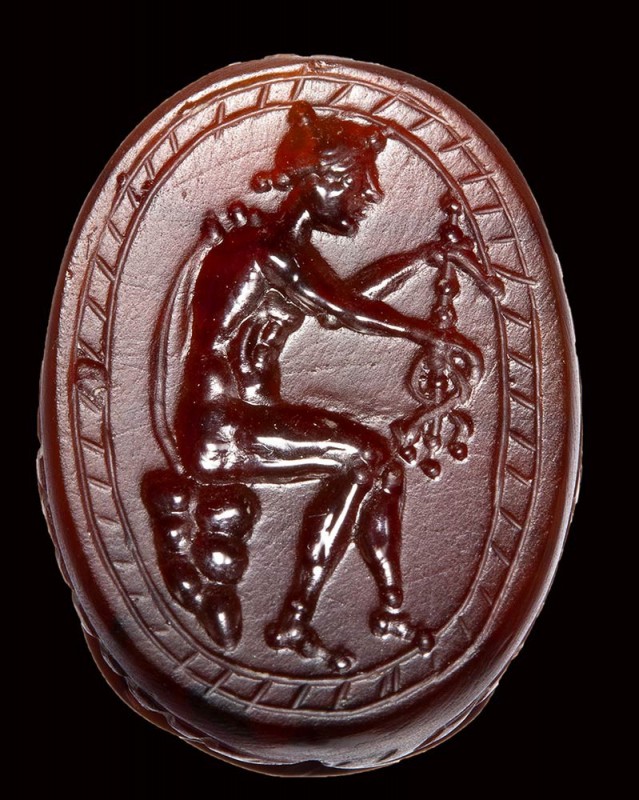 An etruscan carnelian scarab intaglio. Hermes with caduceus.

4th-3rd century ...