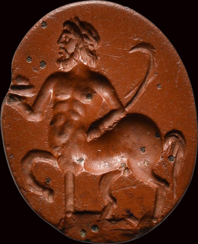 A fine roman red jasper intaglio. Centaur with attributes. 

1st - 2nd century...