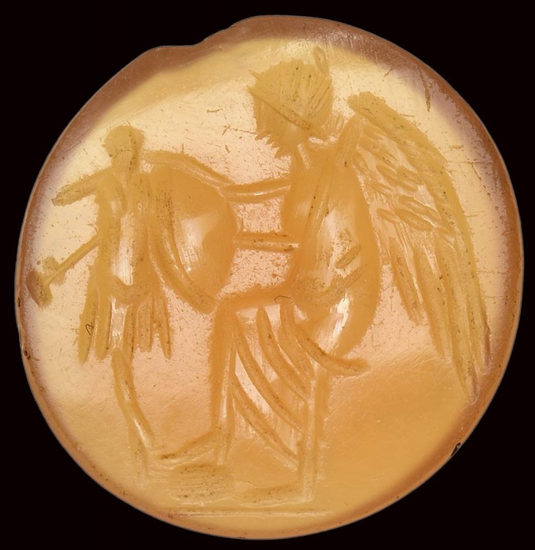 A roman carnelian intaglio. Victory with a trophy. 

2nd - 3rd century A.D.
...
