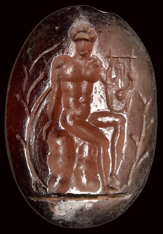 A roman late republican garnet intaglio. Apollo citharedus. 

1st century B.C....