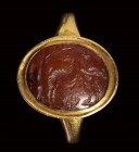 A roman carnelian intaglio mounted in a modern gold ring. Bucolic fight scene.
