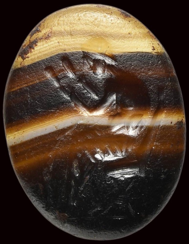 A roman banded agate intaglio. Seated reader. 

2nd century A.D.

10 x 13 x ...