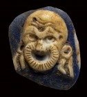 A roman fragment two-layers blue and white glass cameo. Theatrical mask.