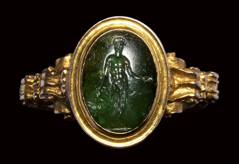 An early Victorian gold ring, set with a roman intaglio in chromian chalcedony. ...