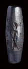A roman hematite magical fusiform amulet. Feminine figure with inscriptions.