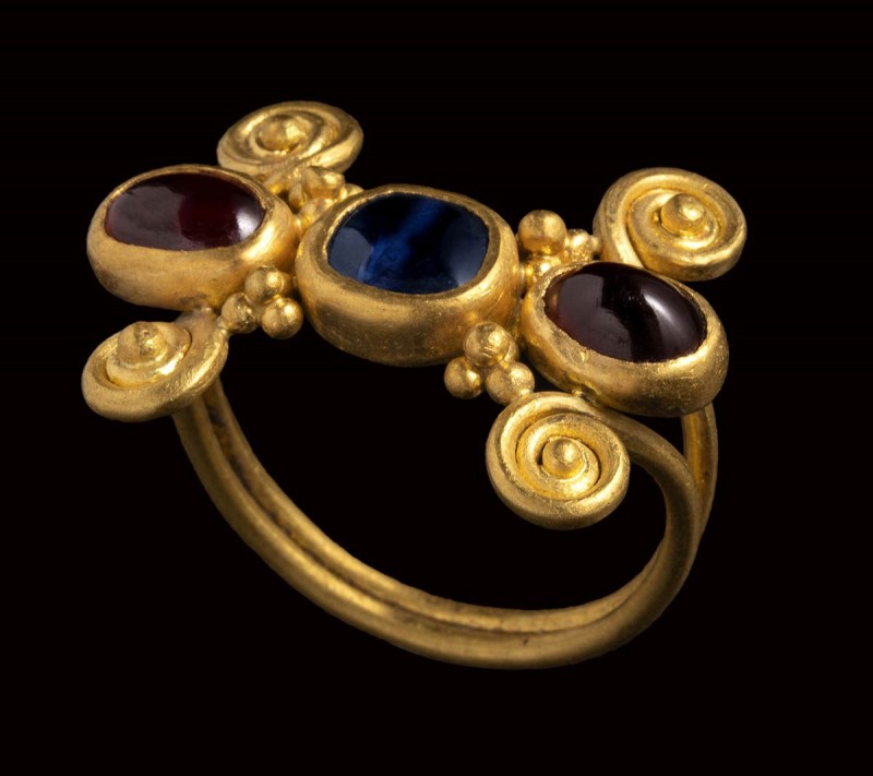 A late roman gold ring set with a shappire and two garnets.

4th century A.D....