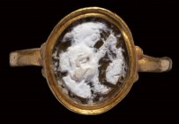 A roman burnt agate cameo mounted in a gold ring. Mythological scene.