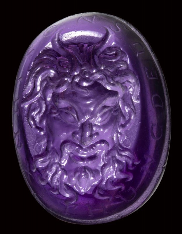 A fine renaissance amethyst intaglio. Mask of Pan with motto

16th century A.D...