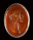 A neoclassical carnelian intaglio mounted on a seal. Bust of Apollo with lyre.