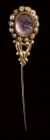 A postclassical amethyst cameo set in a gold stick pin with pearls. Bust of Cupid.