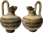 Daunian Oinochoe. The body decorated with brown and red bands. Daunia, 5th century BC. H. 17 cm.