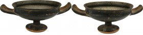 Apulian Kylix. Two handled, low conical foot, black-glazed. Apulia, 4th century BC. H. 8 cm. Diam. 20 cm (including handles).