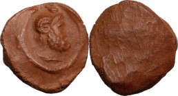 Roman terracotta seal/bulla for papyrus scroll with bust of Serapis. 1st-3rd century AD. 18.50 mm.
