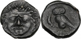 Sicily. Kamarina. AE Tetras or Trionkion, c. 420-405 BC. Gorgoneion. / KAMA. Owl standing left, head facing, grasping lizard; three pellets in exergue...