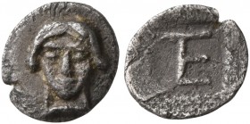 IONIA. Kolophon. Circa 500-450 BC. Tetartemorion (Silver, 7 mm, 0.21 g, 2 h). Facing head of Apollo. Rev. Monogram of ΤΕ (mark of value) within incuse...