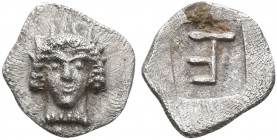 IONIA. Kolophon. Circa 500-450 BC. Tetartemorion (Silver, 7 mm, 0.22 g, 6 h). Facing head of Apollo. Rev. Monogram of TE (mark of value) within incuse...