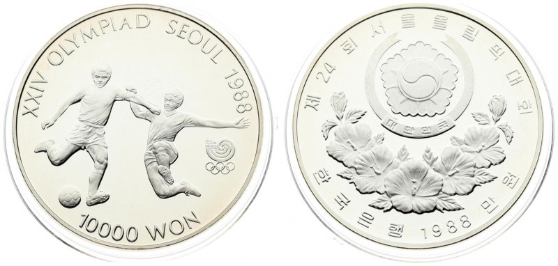 Korea-South 10000 Won 1988 Averse: Arms above floral spray. Reverse: Soccer play...