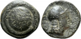 UNCERTAIN. Ae (4th-3rd centuries BC). 

Obv: Shield.
Rev: Head of man right with helmet.

BMC -; SNG von Aulock -; SNG Copenhagen -; Isegrim -. ...