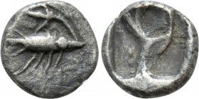 MYSIA. Kyzikos. Obol (6th century BC). 

Obv: Tunny left, holding stem of lotus flower in its mouth.
Rev: Quadripartite incuse square.

CNG E-389...