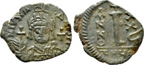 JUSTINIAN I (527-565). Decanummium. Antioch. Dated RY 35 (561/2). 

Obv: Helmeted and cuirassed bust facing, holding globus cruciger and shield deco...