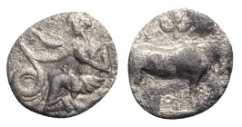 Sicily, Selinos, c. 410 BC. AR Litra (9.5mm, 0.70g, 5h). Nymph seated l. on rock, r. hand raised above her head, touching serpent rising to l.; selino...
