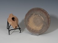 ROMA. Imperio Romano. Lote de dos objetos: lucerna y cuenco (V-VI d.C.). Cerámica. Altura 5,1 cm. Diámetro 13,9 cm. Longitud 8,7 cm.