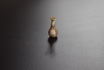Glass flask with globular body and long neck. 1st-2nd cent. AD (34.4 x 16.1mm). Surface weathered, damaged at the rim