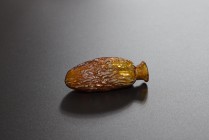Date flask, amber coloured glass. Eastern Mediterranean, 1st - 2nd cent. AD. (68.9 x 28.5mm). Beautifully structured body, intact.