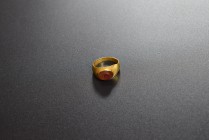 Golden ring with gemstone of red cornelian depicting an animal with horns coming out of a calyx. AV (19.4 mm, 4.86 g). 2nd-3rd cent. AD. Almost intact