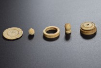Lot of 6 bone and horn objects, including 4 spindle whorls and 2 need's heads. 1st-3rd cent. AD.