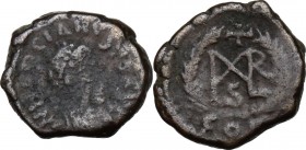 Marcian (450-457). AE Nummus. Constantinople mint. Pearl–diademed, draped, and cuirassed bust right. / Cross above monogram of Marcian, all within wre...