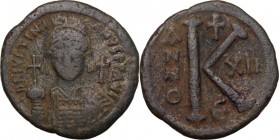 Justinian I (527-565). AE Half Follis. Constantinople mint. Dated RY 12 (538/9). Helmeted and cuirassed bust facing, holding globus cruciger and shiel...