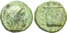 IONIA. Kolophon. Ae (Circa 389-350 BC). 

Obv: Head of Apollo right, wearing tainia.
Rev: KOΛOΦΩNION /ZH. 
Lyre with five strings; laurel leaf in ...