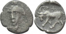 IONIA. Phygela. Hemiobol (Circa 400-380 BC). 

Obv: Head of Artemis Munychia facing slightly left.
Rev: Bull butting left, palm frond and cross abo...